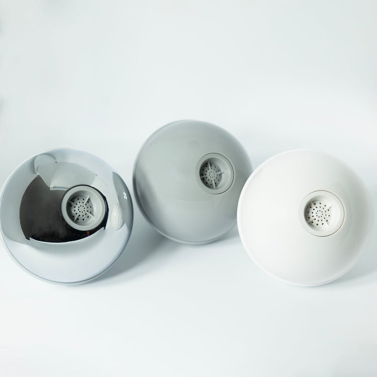 Three globe shaped fixed shower heads in white, grey and chrome